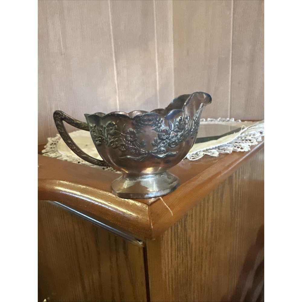 vintage silver-plated gravy or sauce boat with a floral‎ repoussé design.